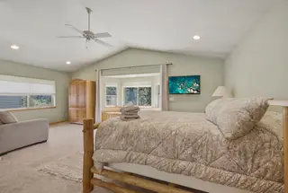 Bedroom 1 — queen log bed, bay window seat, upstairs.