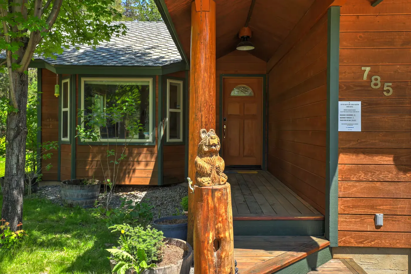 The front porch of The Rabbit Hole with the carved bear